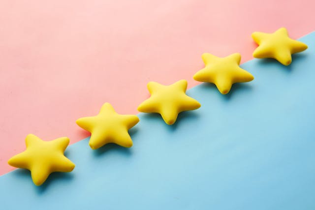 Five yellow stars on blue and pink background